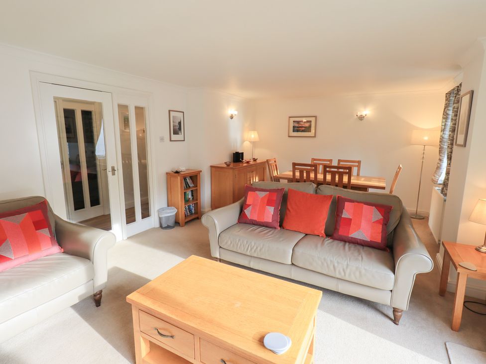A living room containing a sofa and dining table at Mardale in Ambleside