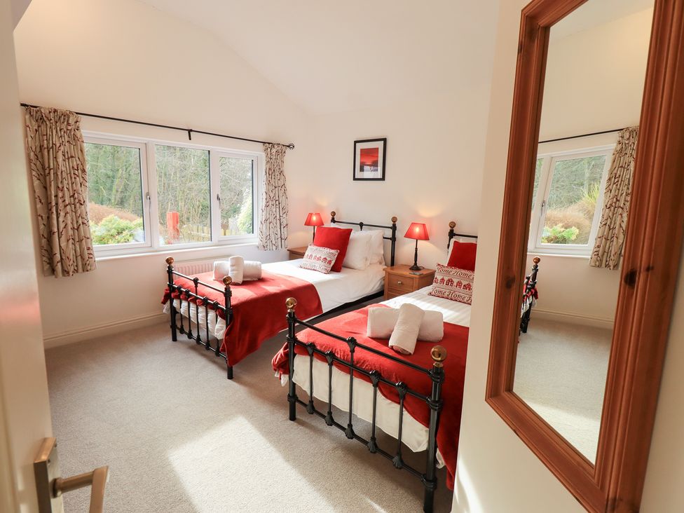 A bedroom with two beds and lamps at Mardale in Ambleside