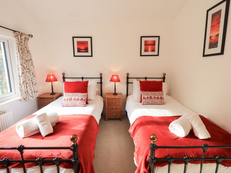 A bedroom with two beds and lamps at Mardale in Ambleside