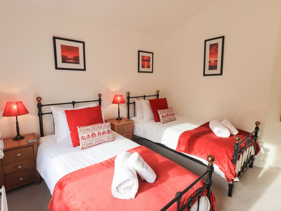 A bedroom with two beds and lamps at Mardale in Ambleside