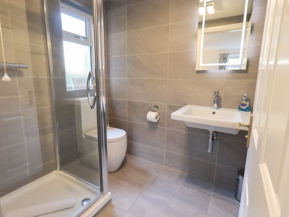 A bathroom with a shower, toilet and sink at Mardale in Ambleside