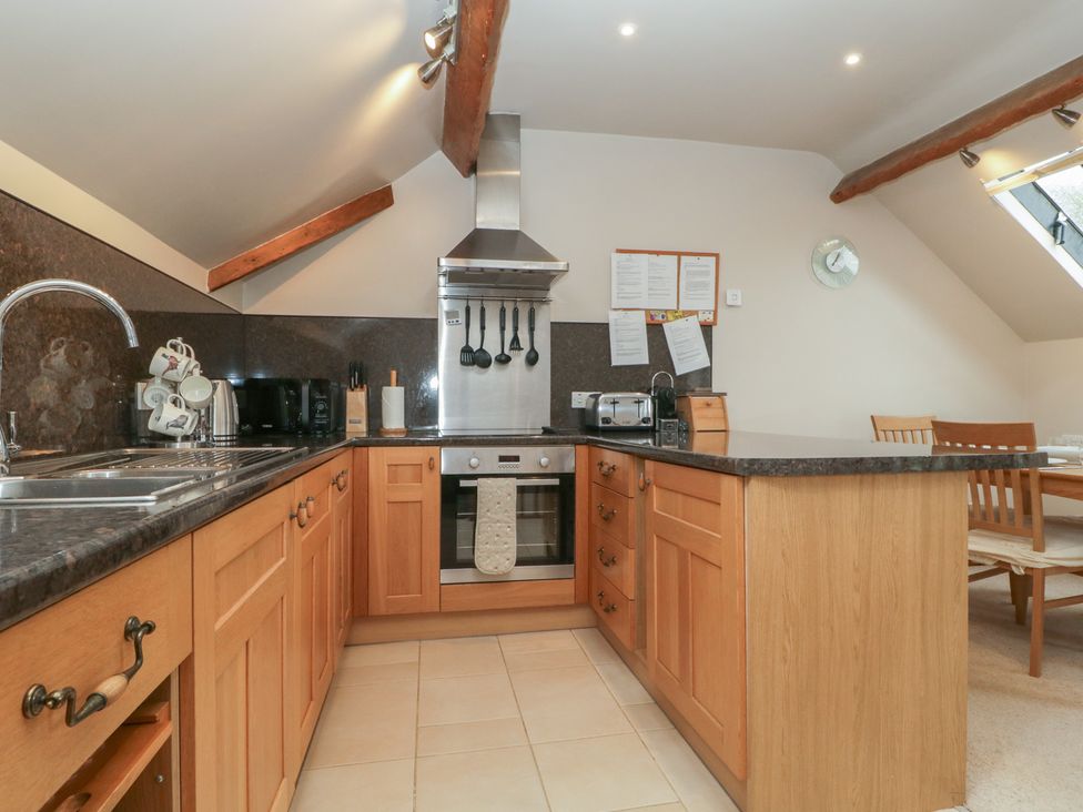 A kitchen with appliances and utensils at Cygnet Cottage Thornthwaite