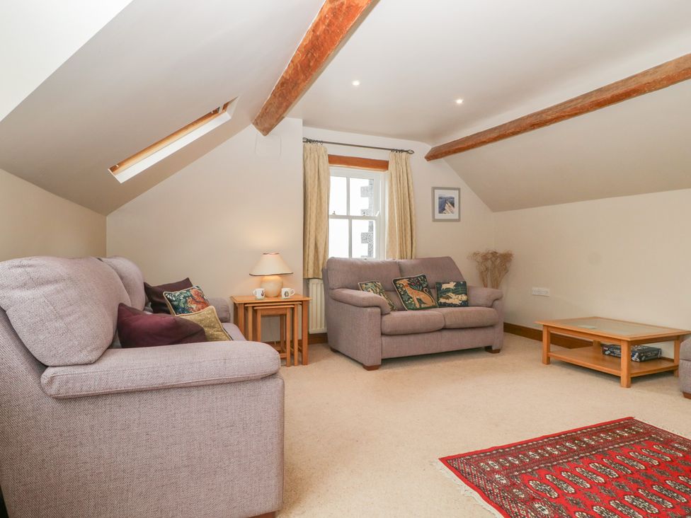 A living room with sofas and a coffee table at Cygnet Cottage Thornthwaite