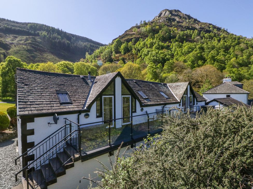 A house with a railing and stairs at Cygnet Cottage in Thornthwaite