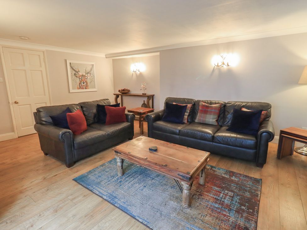 A living room with sofas and a coffee table at Chapel Hill Cottage in Ambleside