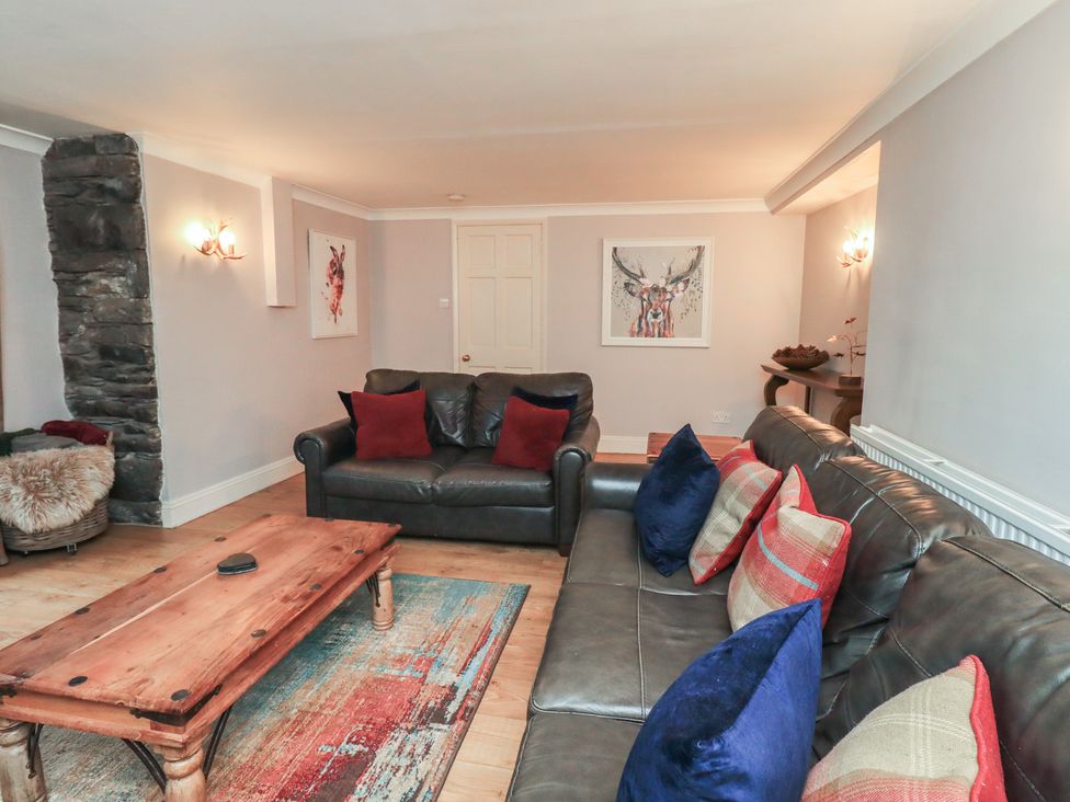 A living room with a sofa and coffee table at Chapel Hill Cottage Ambleside