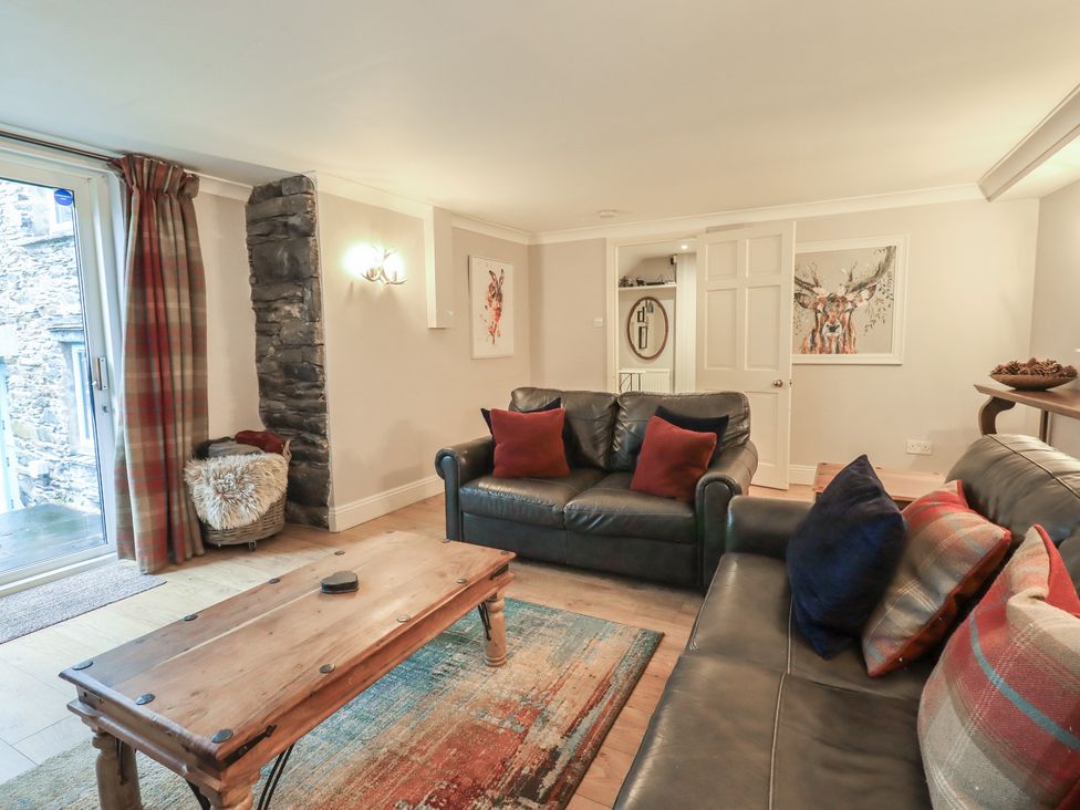 A living room with a sofa and coffee table at Chapel Hill Cottage in Ambleside