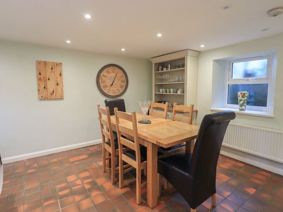 A dining room with a wooden table and chairs at Chapel Hill Cottage in Ambleside