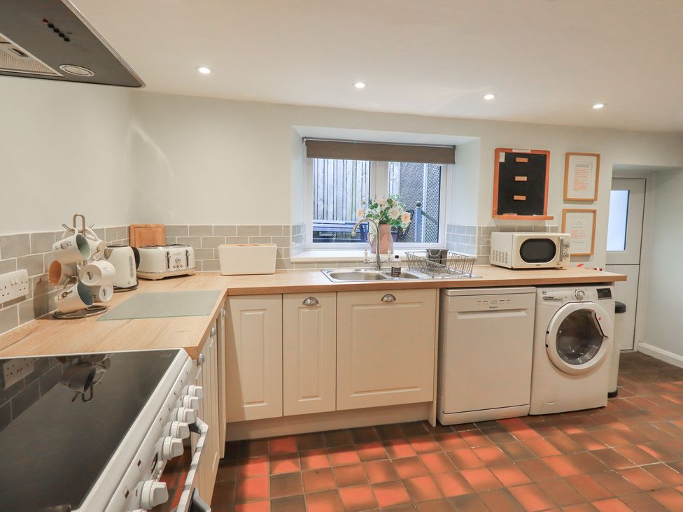 A kitchen with a sink and appliances at Chapel Hill Cottage in Ambleside