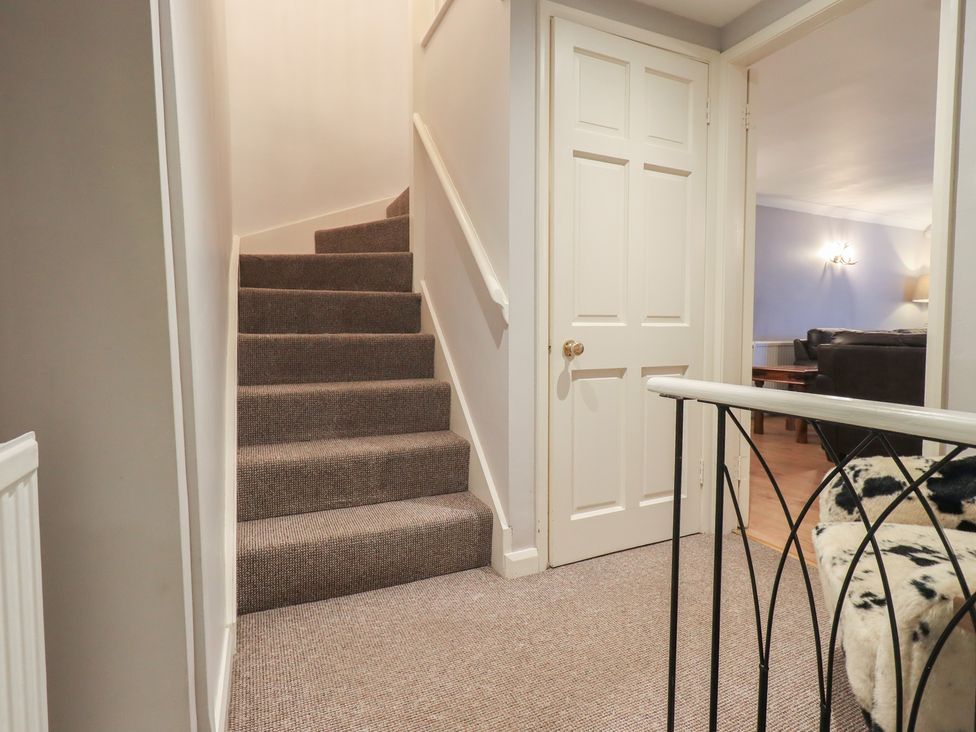 A hallway with stairs leading up at Chapel Hill Cottage in Ambleside