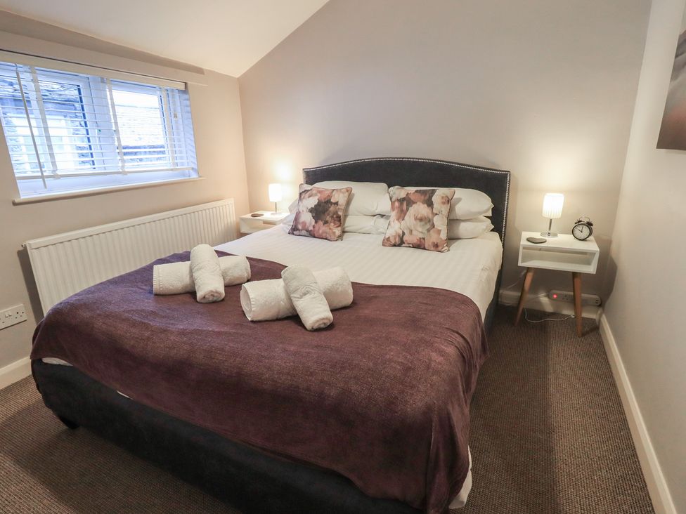 A bedroom with a double bed and nightstand at Chapel Hill Cottage in Ambleside