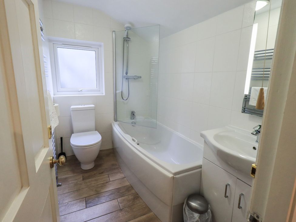 A bathroom with a bathtub and a shower at Chapel Hill Cottage in Ambleside