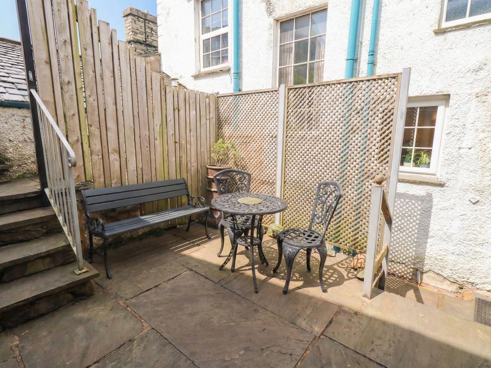 An outdoor patio with a table and chairs at Chapel Hill Cottage in Ambleside