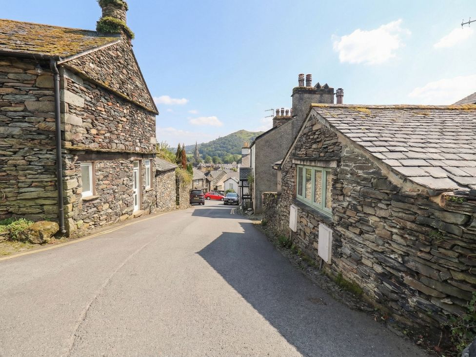 A road between stone buildings at Chapel Hill Cottage in Ambleside