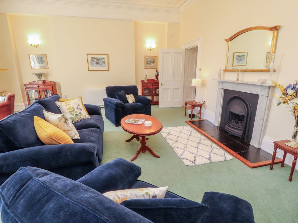 A living room with a sofa and fireplace at South View in Keswick