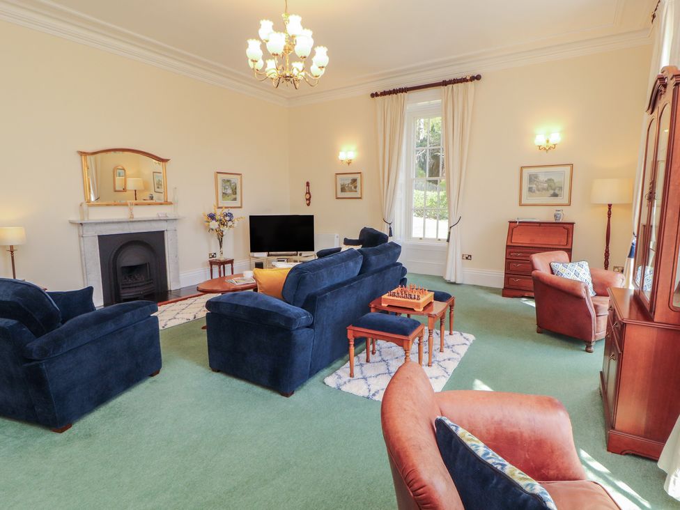 A living room with sofas and a television at South View in Keswick