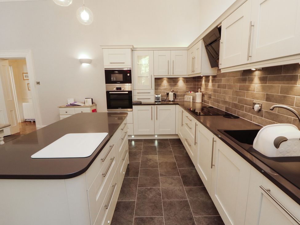 A kitchen with modern cabinets and appliances at South View in Keswick