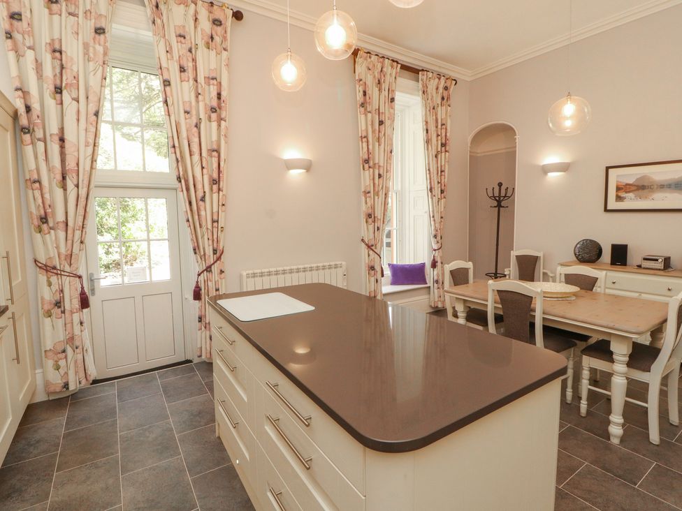 A kitchen with an island and dining area at South View in Keswick