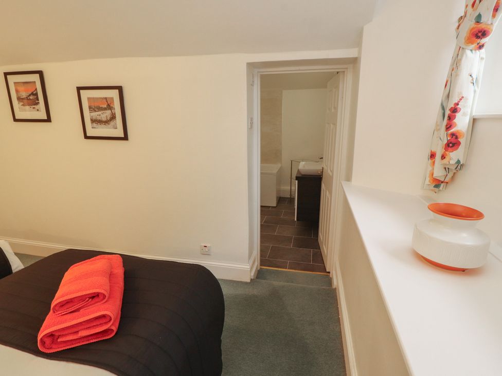 A bedroom with a bed and bright towels at South View in Keswick
