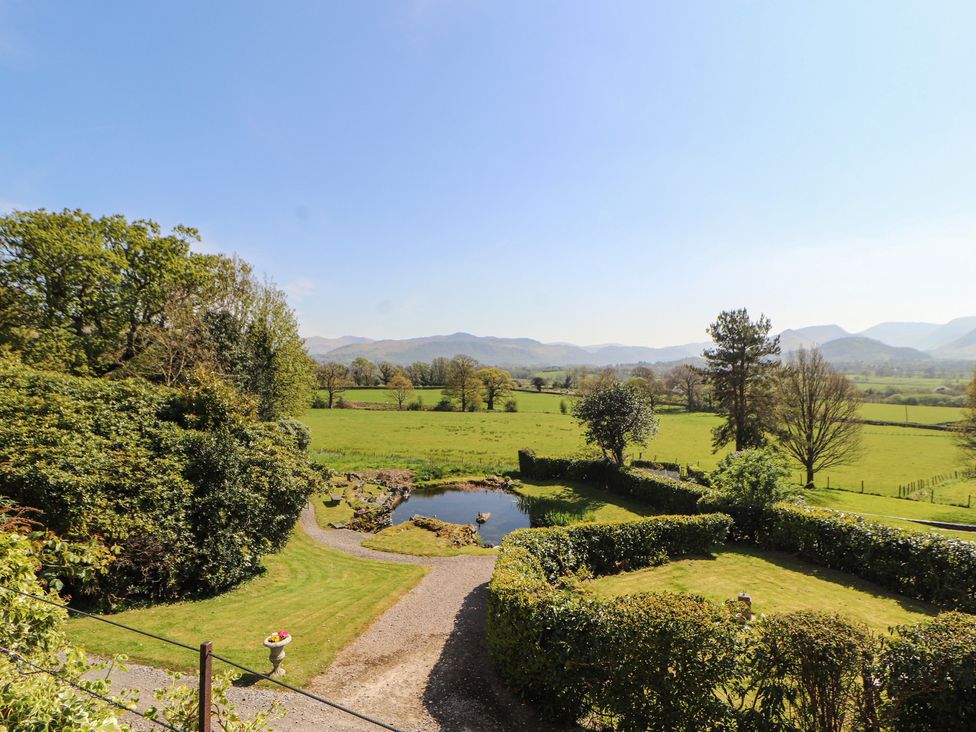 A garden with a pond and hedges at South View in Keswick