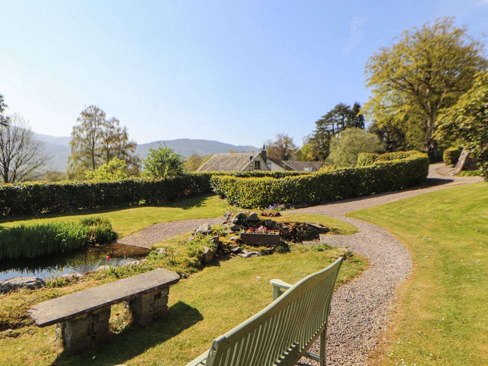A garden with a pathway and bench at South View in Keswick