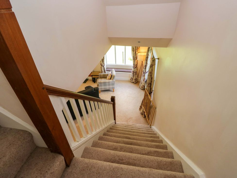 A landing with a staircase and seating area at Elterwater Lodge, Elterwater