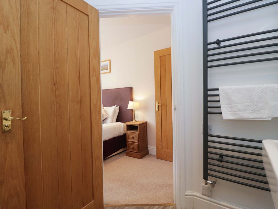 A bedroom view with a bed and nightstand at Elterwater Lodge in Elterwater