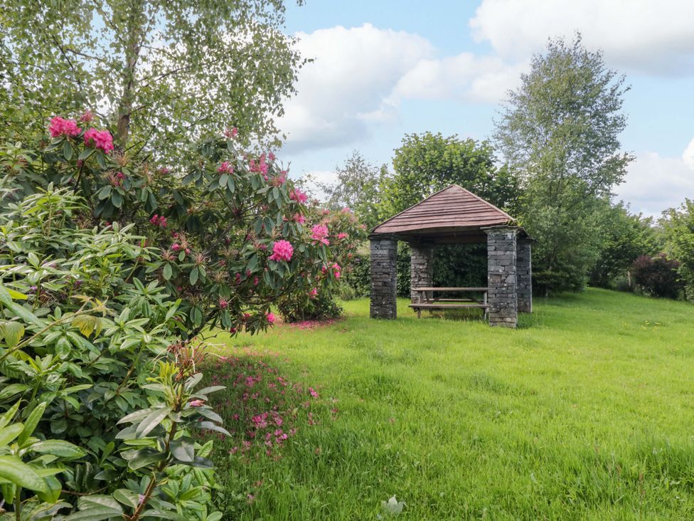 A garden with a gazebo and flowers at Elterwater Lodge in Elterwater