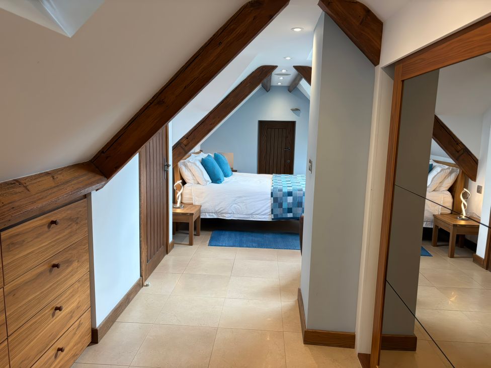 A bedroom with a bed and bedside table at Dancing Beck Cottage in Millbeck