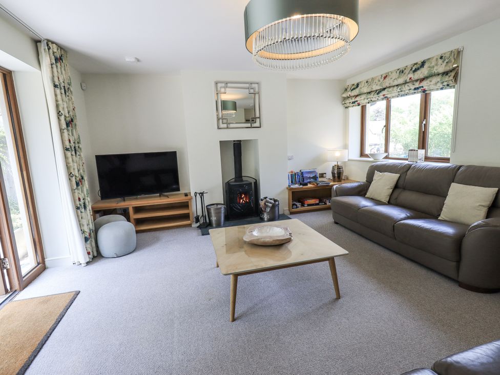A living room with a fireplace and television at No 7 Ambleside