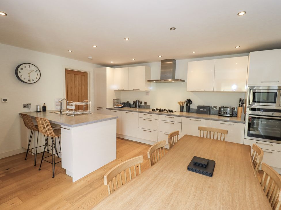 A kitchen with a dining table and stools at No 7 in Ambleside