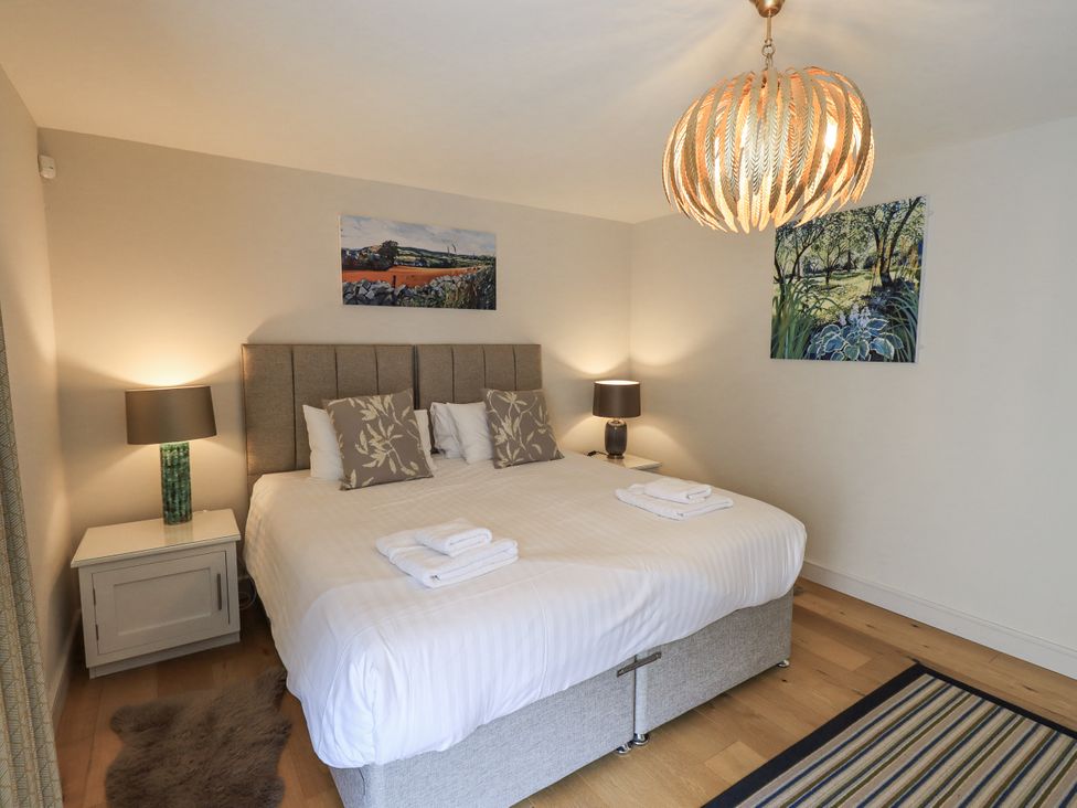 A bedroom with a double bed and decorative lights at No 7 Ambleside