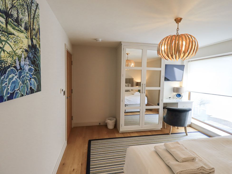 A bedroom with a wardrobe and lamp at No 7 in Ambleside