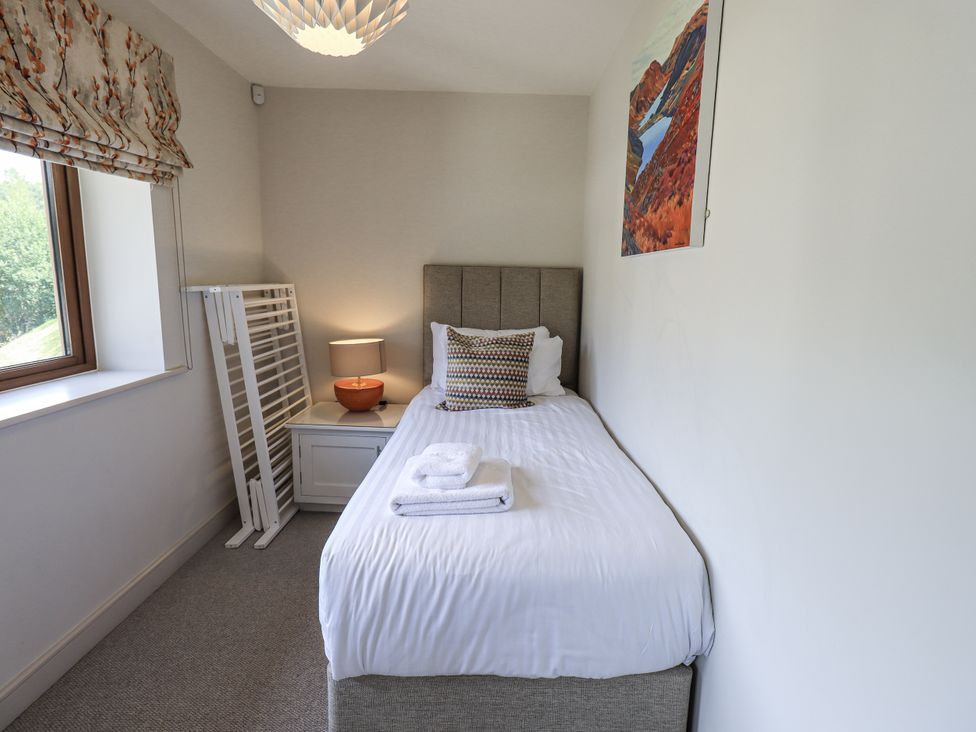 A bedroom with a single bed and a lamp at No 7 in Ambleside