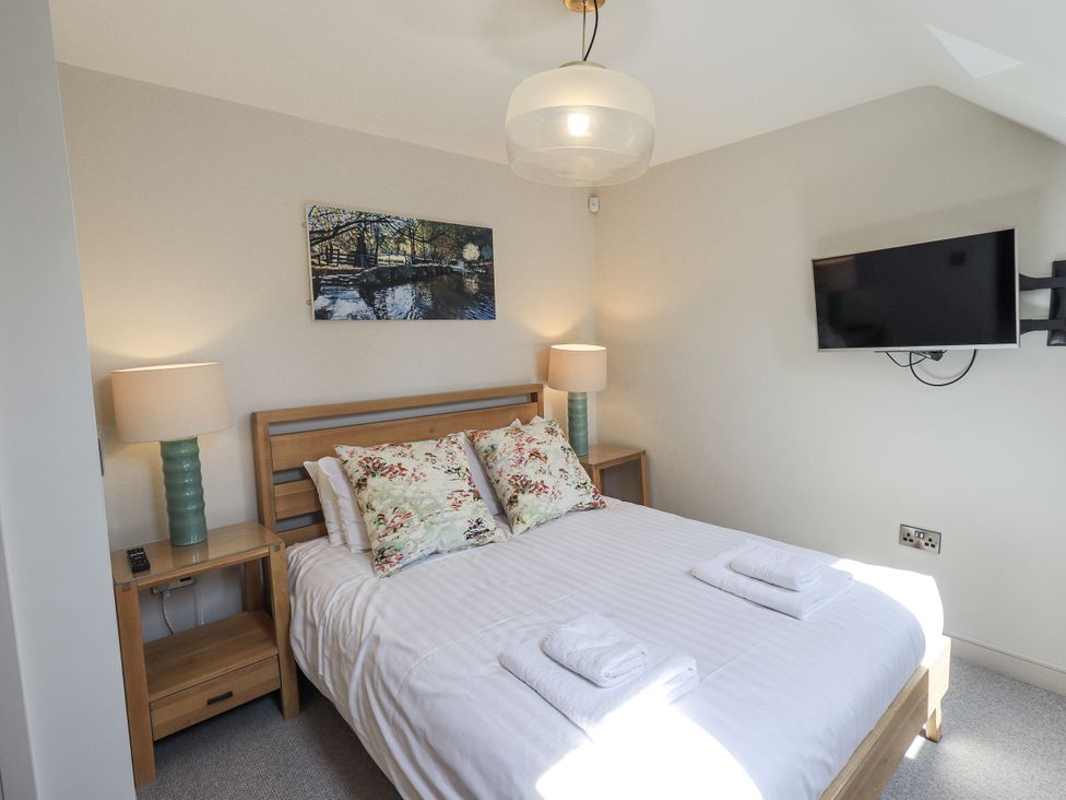 A bedroom with a bed and television at No 7 Ambleside