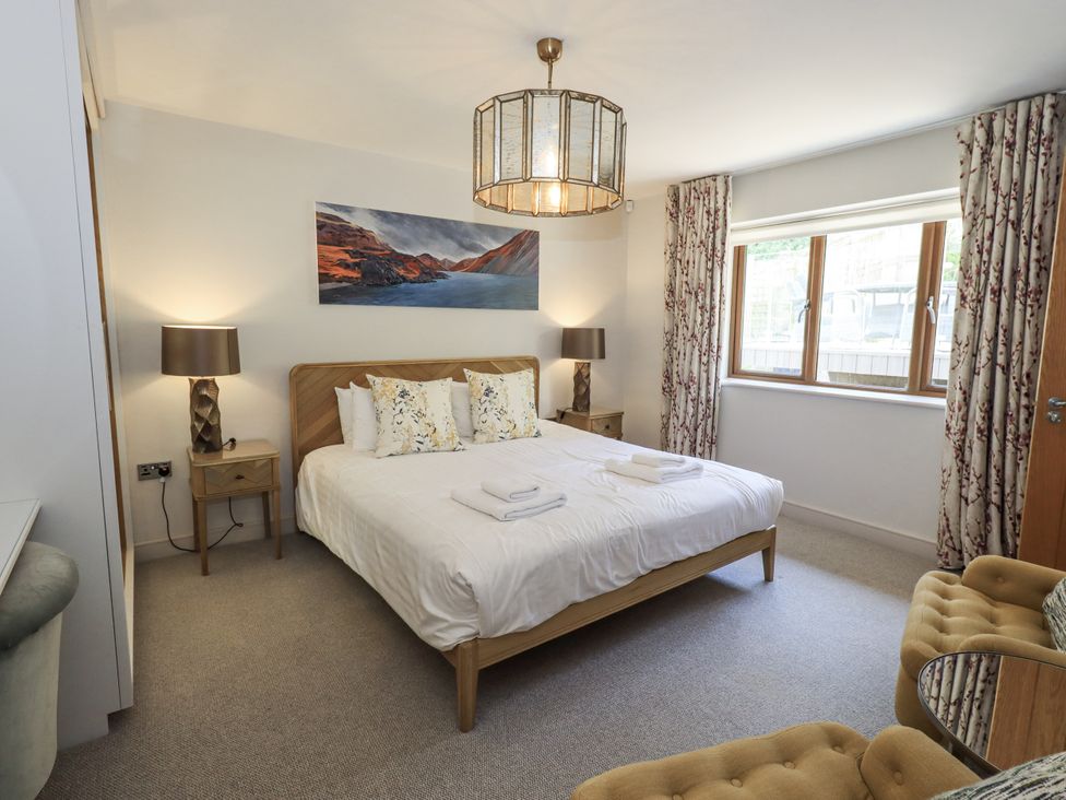 A bedroom with a bed and side tables at No 7 in Ambleside