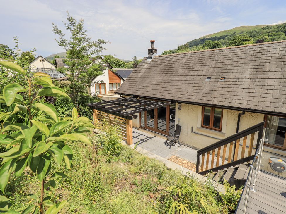 An outdoor view of a house with a garden and patio at No 7 Ambleside