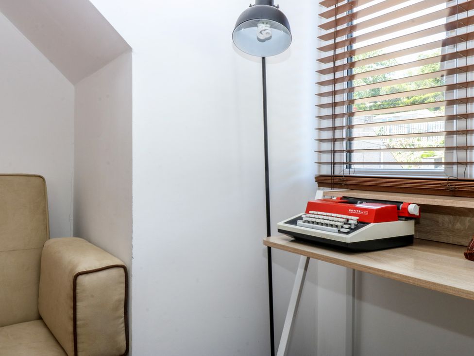 An inner office with a typewriter and lamp at Sea View in Llandudno