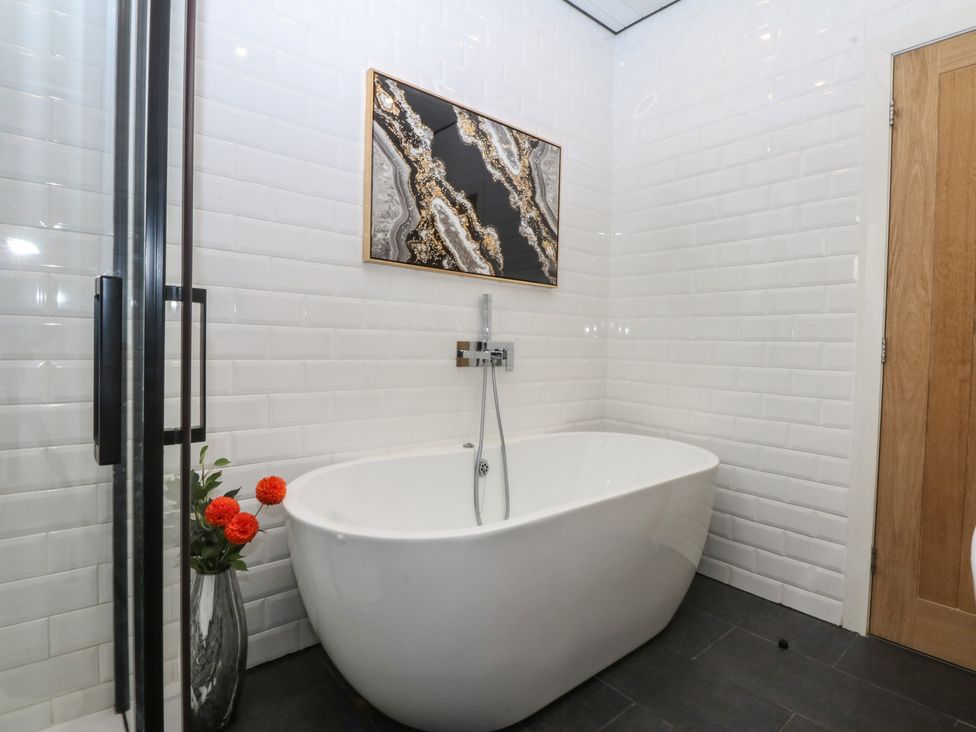 A bathroom with a bathtub and shower at Sea View in Llandudno