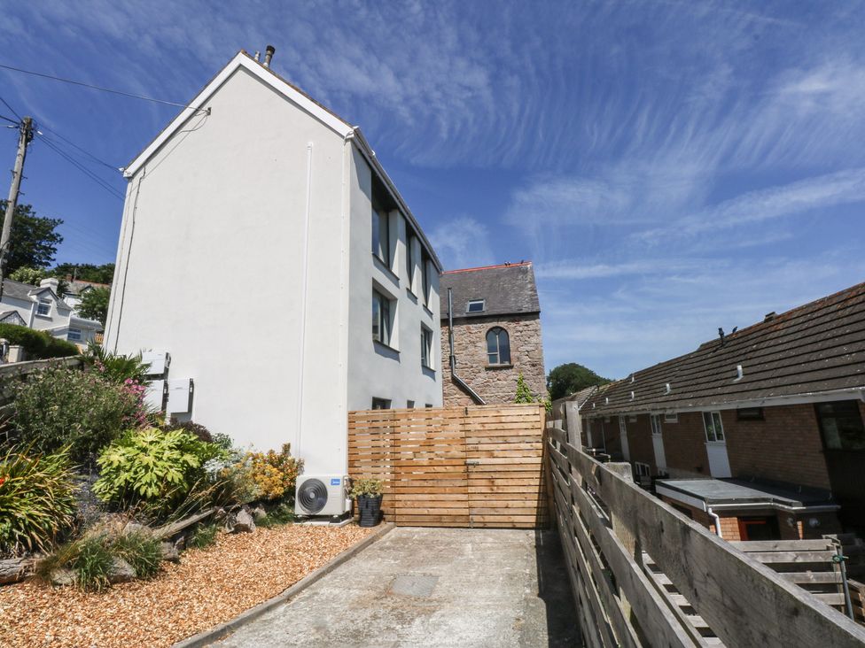 An outdoor area with a building and wooden fence at Sea View in Llandudno
