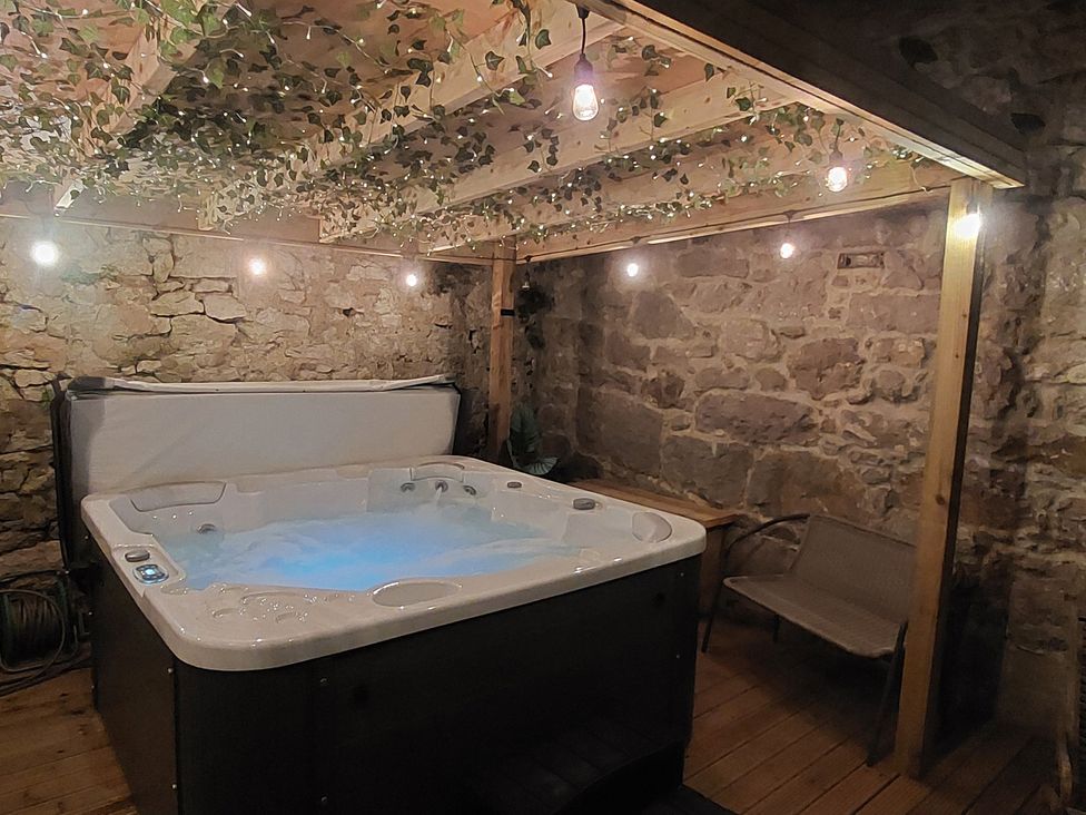 A hot tub with lights and wooden features at Seascape in Llandudno