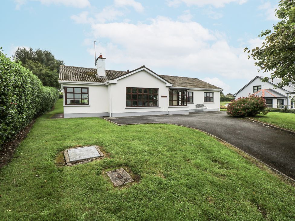 A bungalow with a driveway and grass garden at Brow O' The Hill in Ballyshannon