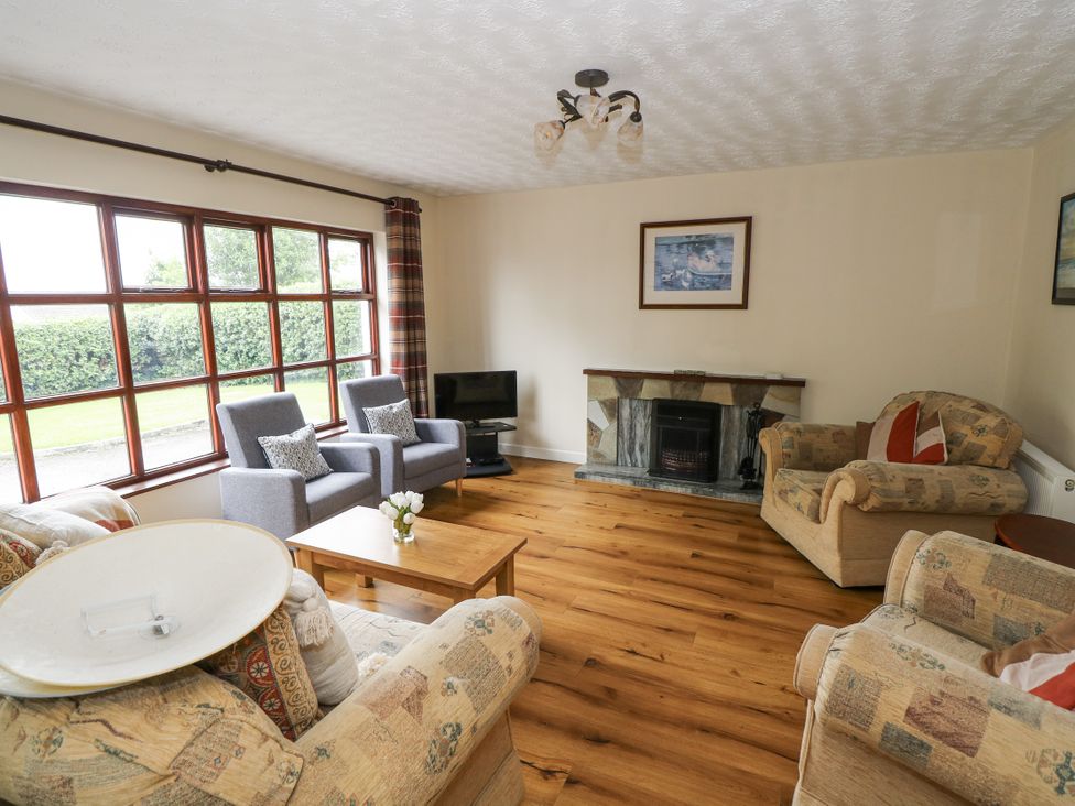 A living room with furniture and a fireplace at Brow O' The Hill in Ballyshannon
