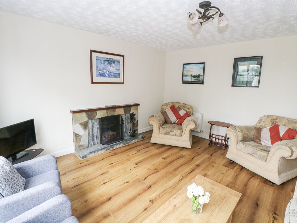 A living room with a fireplace and seating arrangements at Brow O' The Hill in Ballyshannon