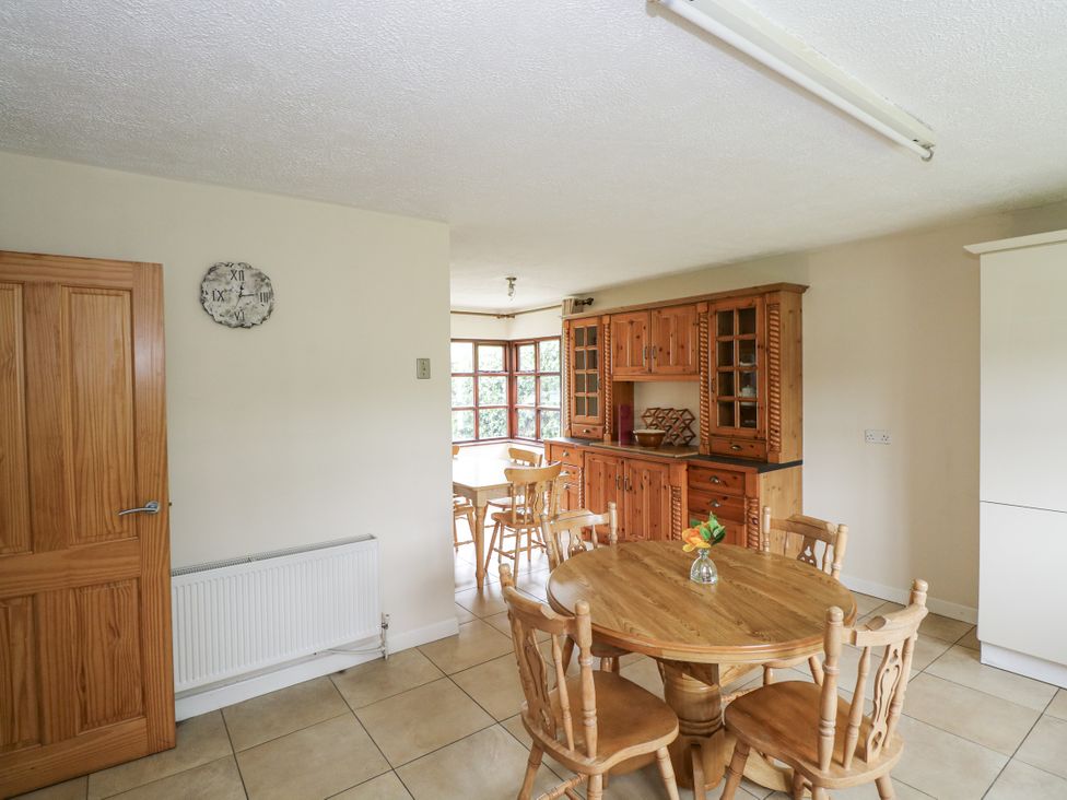 A kitchen with wooden furniture and a radiator at Brow O' The Hill in Ballyshannon