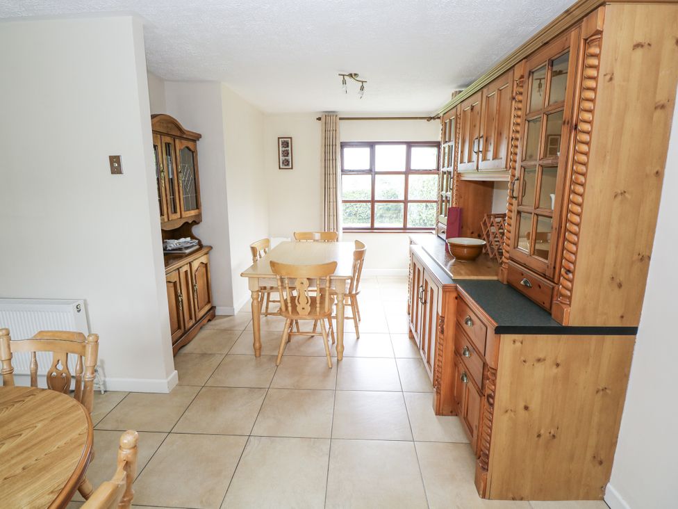 A kitchen with wood furniture and a window at Brow O' The Hill in Ballyshannon