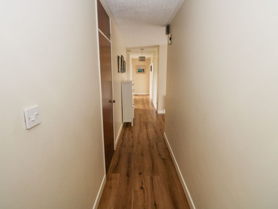 A hallway with wooden flooring and light fixture at Brow O' The Hill in Ballyshannon