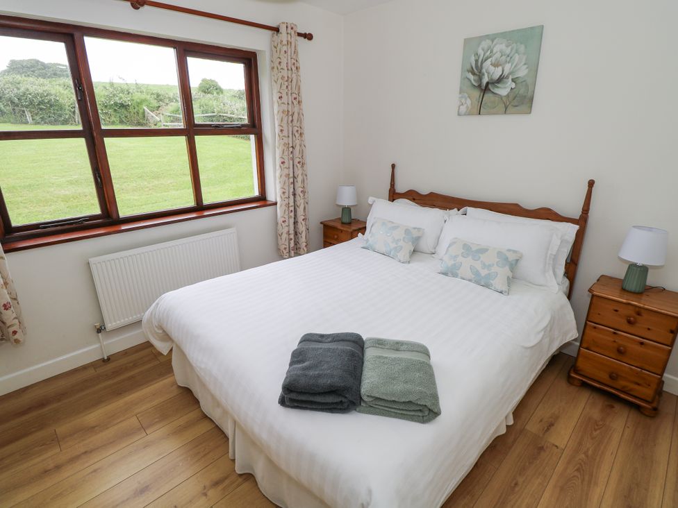A bedroom with a bed and nightstands at Brow O' The Hill in Ballyshannon