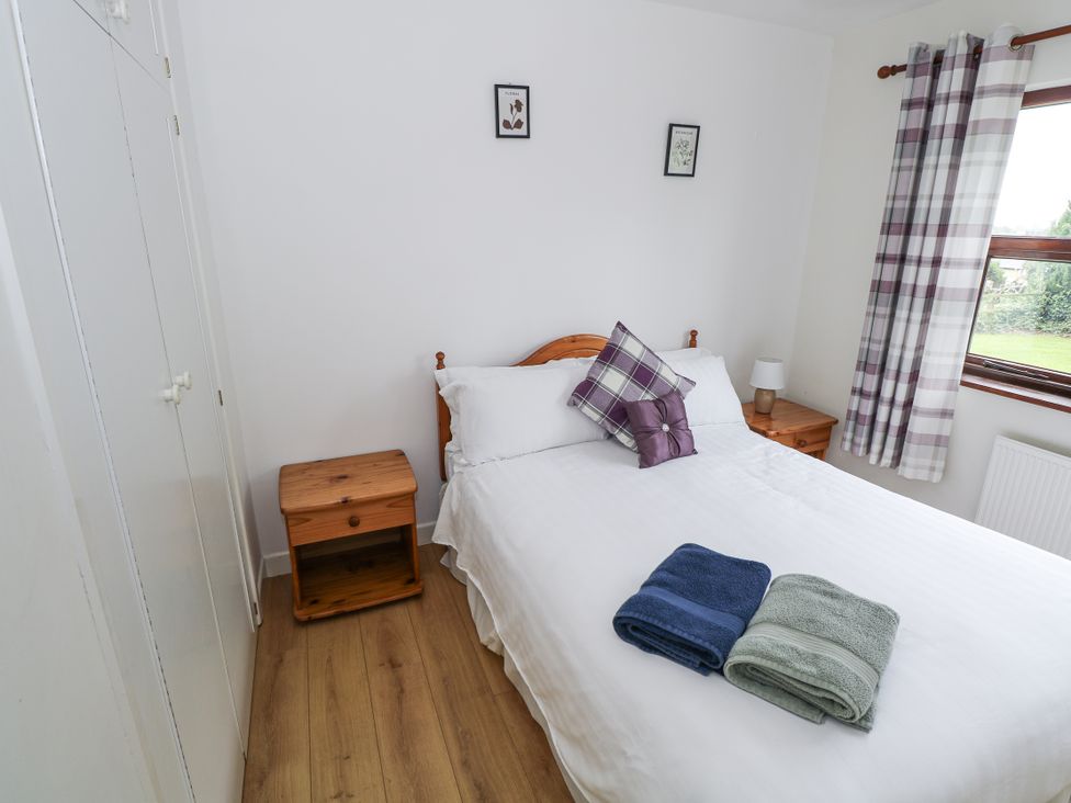A bedroom with a bed and nightstand at Brow O' The Hill in Ballyshannon