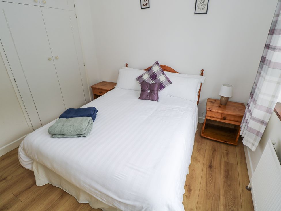 A bedroom with a bed and towels at Brow O' The Hill in Ballyshannon
